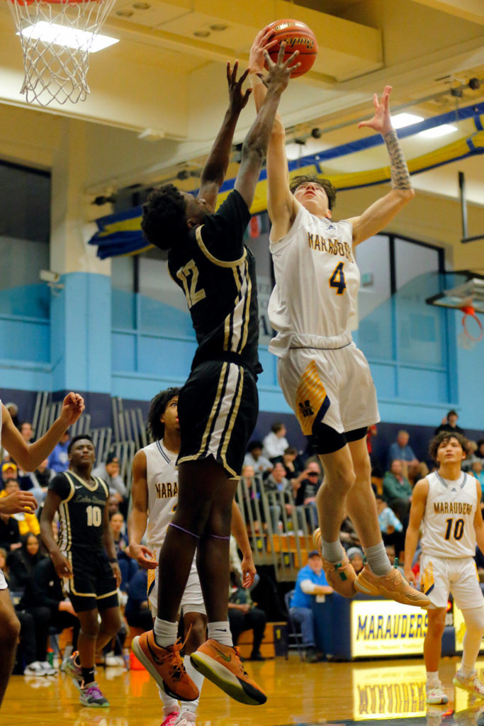 Mariner’s Riley Weimer and Lake Stevens’ Mekhi Hunter both try to come down with a rebound on Thursday, Feb. 2, 2023, at Mariner High School in Everett, Washington. (Ryan Berry / The Herald)
