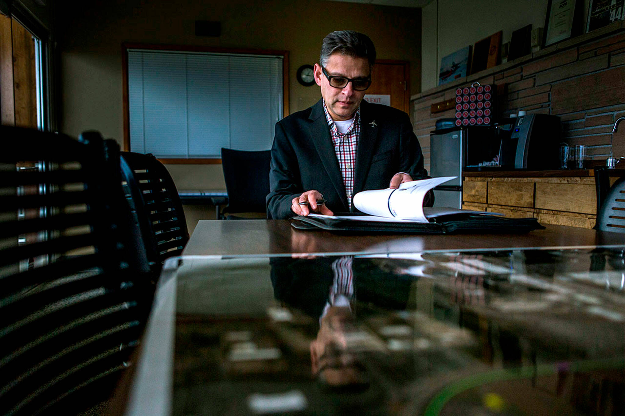 Arif Ghouse flips through his work binder in his office conference room Paine Field on Dec. 10, 2018 in Everett. (Olivia Vanni / The Herald)
Arif Ghouseat flips through his work binder in his office conference room Paine Field on Dec. 10, 2018 in Everett. (Olivia Vanni / The Herald)