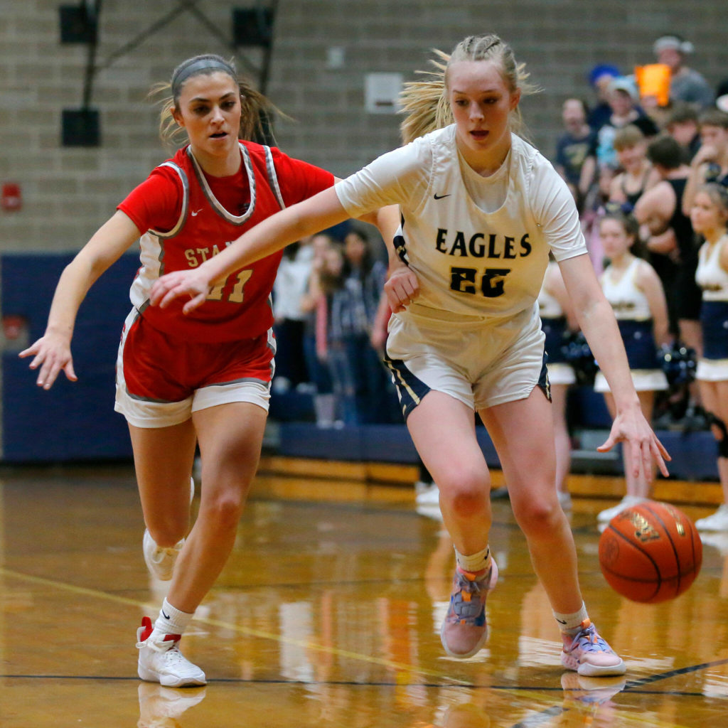 Arlington’s Kierra Reese tries to keep away from a defender against Stanwood on Jan. 25 in Arlington. The two-time defending 3A District 1 champion Eagles enter this season’s tournament with the top seed. (Ryan Berry / The Herald)
