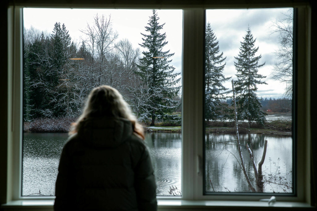 A visitor takes in the view of Twin Lakes from a second floor unit at Housing Hope’s Twin Lakes Landing II on Wednesday, in Marysville. (Ryan Berry / The Herald)
