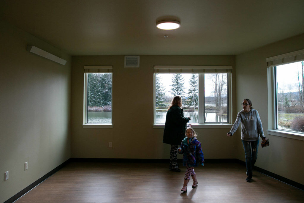 
A family takes a self-guided tour of an apartment after a ribbon-cutting ceremony at Housing Hope’s Twin Lakes Landing II on Wednesday, in Marysville. (Ryan Berry / The Herald) 

