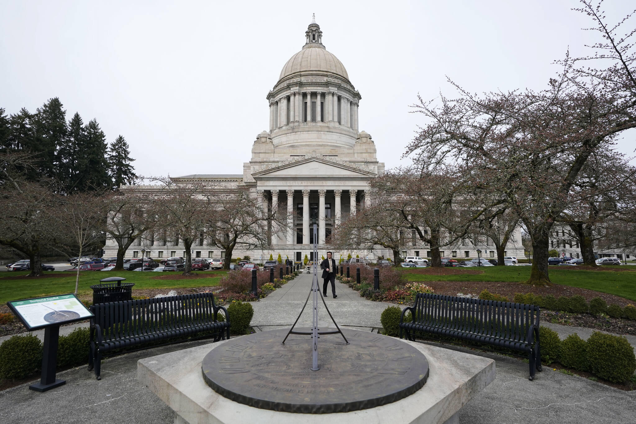 FILE - The sun dial near the Legislative Building is shown under cloudy skies, March 10, 2022, at the state Capitol in Olympia, Wash. An effort to balance what is considered the nation's most regressive state tax code comes before the Washington Supreme Court on Thursday, Jan. 26, 2023, in a case that could overturn a prohibition on income taxes that dates to the 1930s. (AP Photo/Ted S. Warren, File)