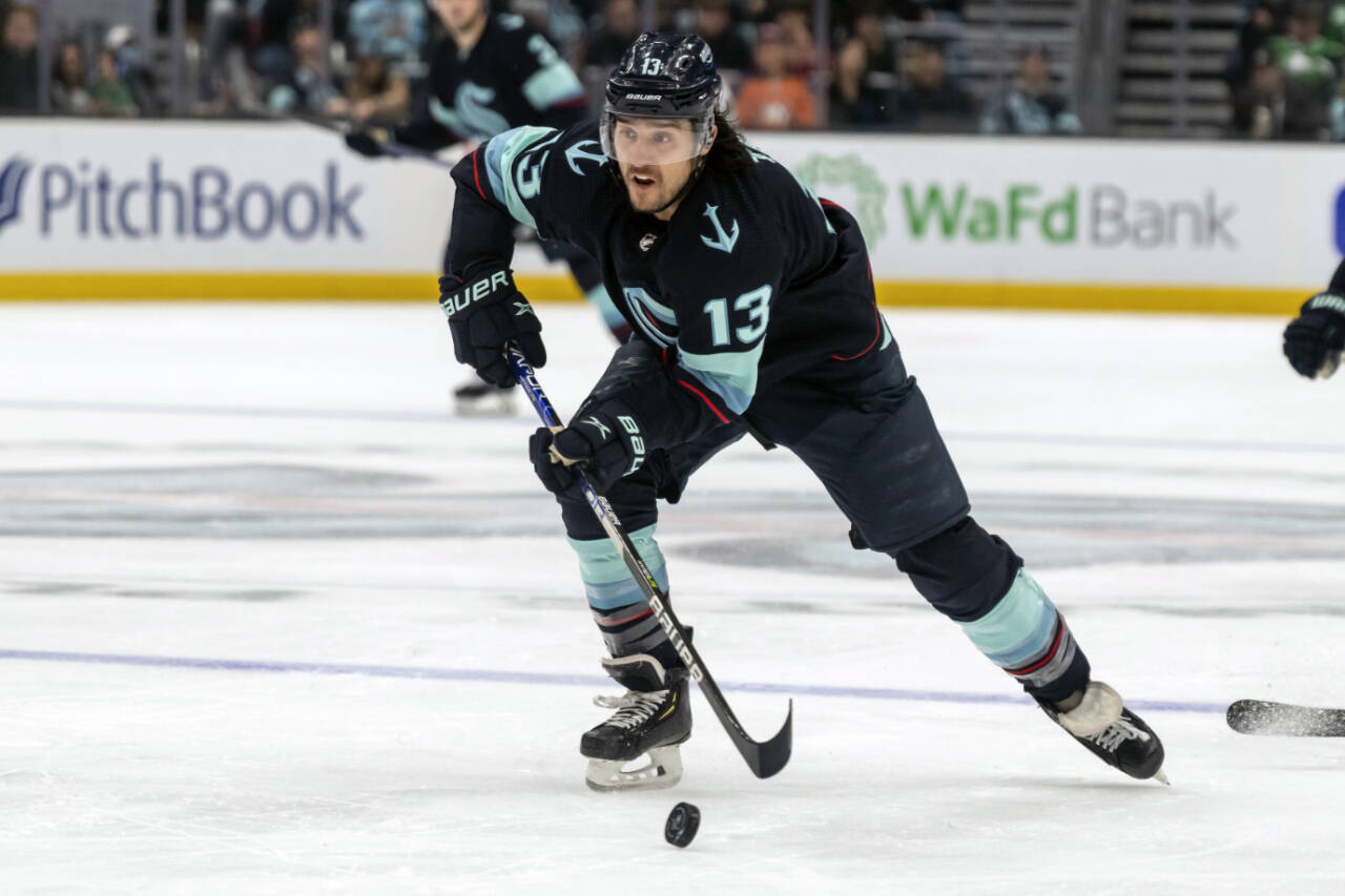 Seattle Kraken forward Brandon Tanev skates with the puck during a game against the New York Islanders on Jan. 1 in Seattle. (AP Photo/Stephen Brashear)