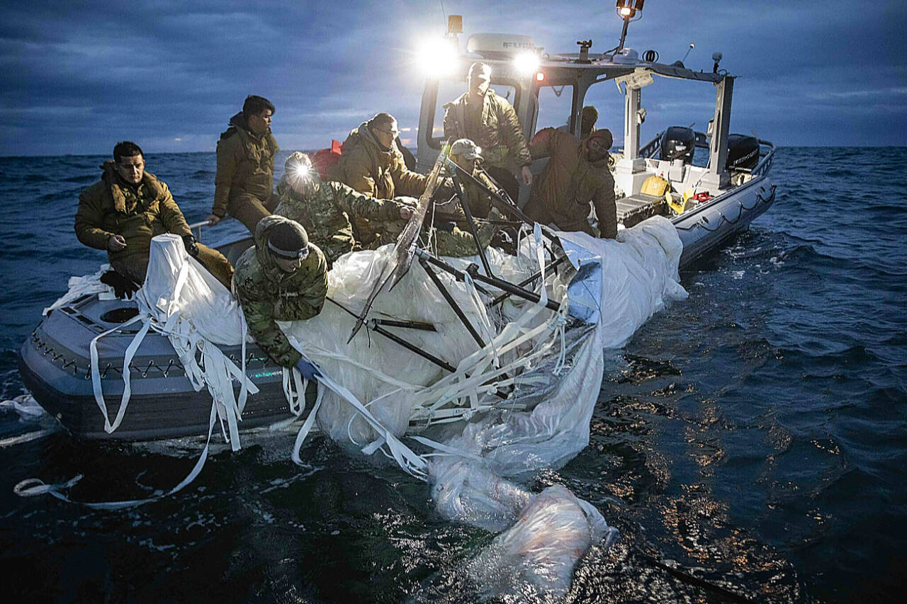 U.S. Navy sailors assigned to Explosive Ordnance Disposal Group 2 recover a high-altitude surveillance balloon off the coast of Myrtle Beach, S.C., Feb. 5. (U.S. Navy via Associated Press)