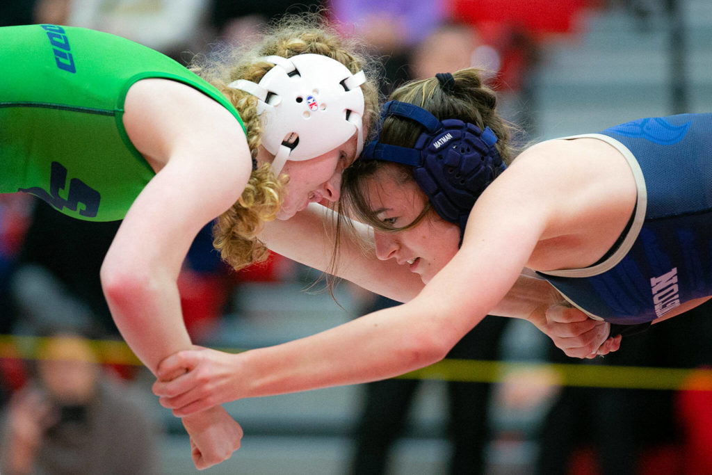 Shorewood’s Libby Norton and Arlington’s Araxi Crew grapple with each other during the 3A/4A Girls Region 1 Wrestling Tournament on Saturday, Feb. 11, 2023, at Snohomish High School in Snohomish, Washington. (Ryan Berry / The Herald)
