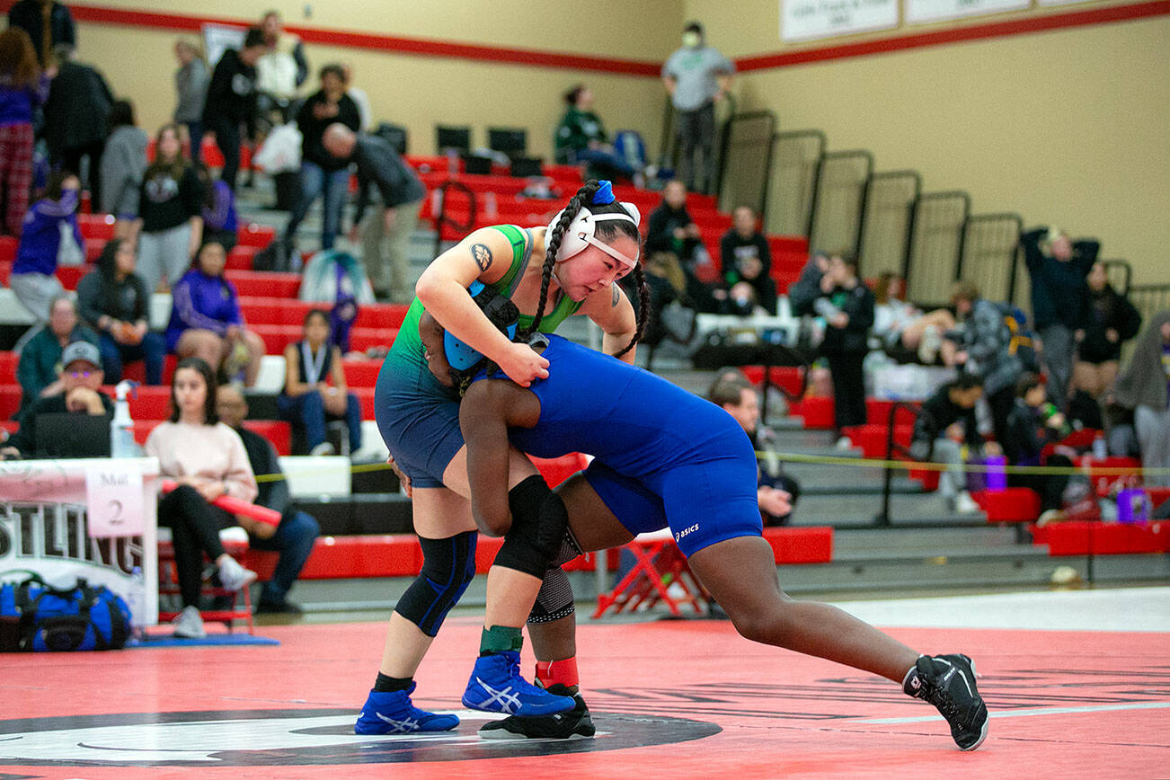 Shorewood’s Abbi Chishungu tries to take down teammate Kiana Yoshimura during the 3A/4A Girls Region 1 Wrestling Tournament on Saturday, Feb. 11, 2023, at Snohomish High School in Snohomish, Washington. (Ryan Berry / The Herald)