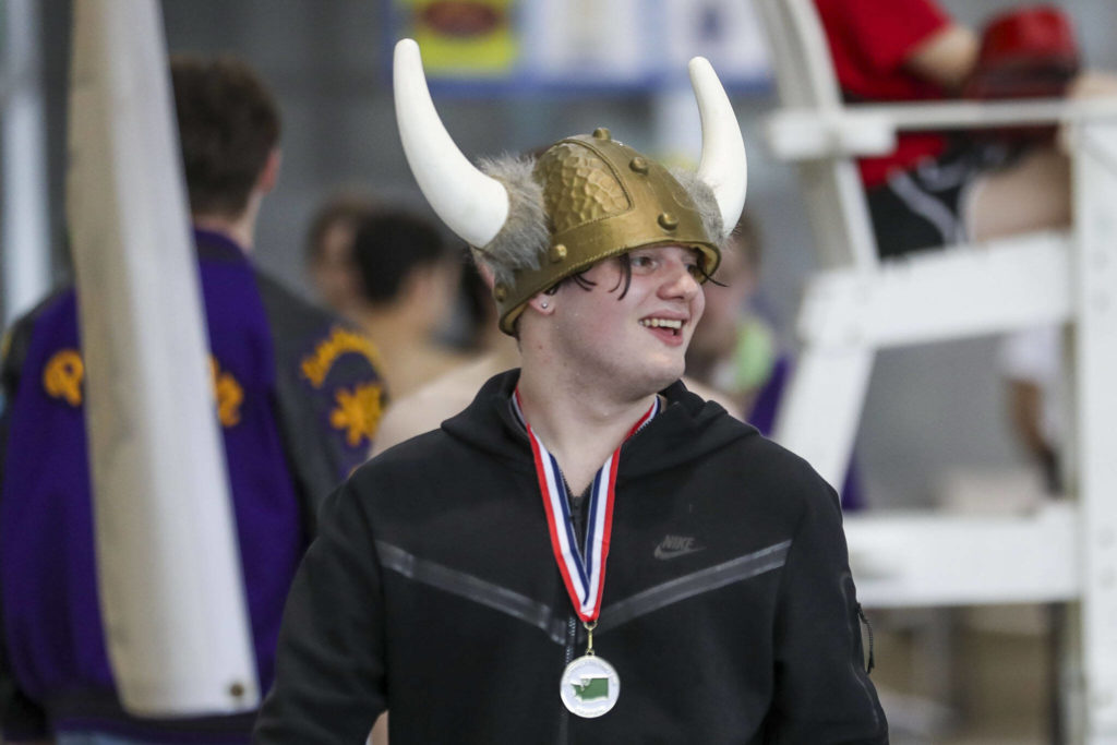 Lake Stevens’ Garrett Chesley smiles after winning the 100 Yard Butterfly during the 4A District 1 swim and dive championships at Snohomish Aquatic Center, in Snohomish, Washington on Saturday, Feb. 11, 2023. (Annie Barker / The Herald)
