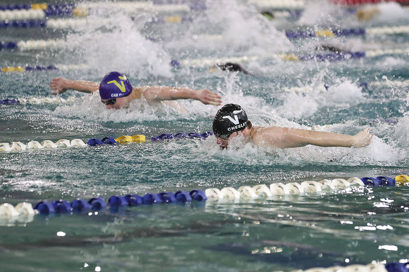 Lake Stevens’ Garrett Chesley wins Heat 2 of the 100 Yard Butterfly during the 4A District 1 swim and dive championships at Snohomish Aquatic Center, in Snohomish, Washington on Saturday, Feb. 11, 2023.  (Annie Barker / The Herald)