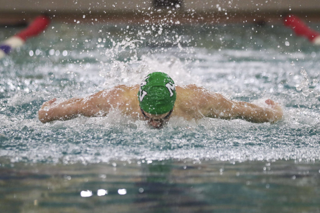 Mount Vernon’s Wyatt Carlton wins Heat 2 of the 100 Yard Butterfly during the 3A District 1 swim and dive championships at Snohomish Aquatic Center, in Snohomish, Washington on Saturday, Feb. 11, 2023. (Annie Barker / The Herald)

