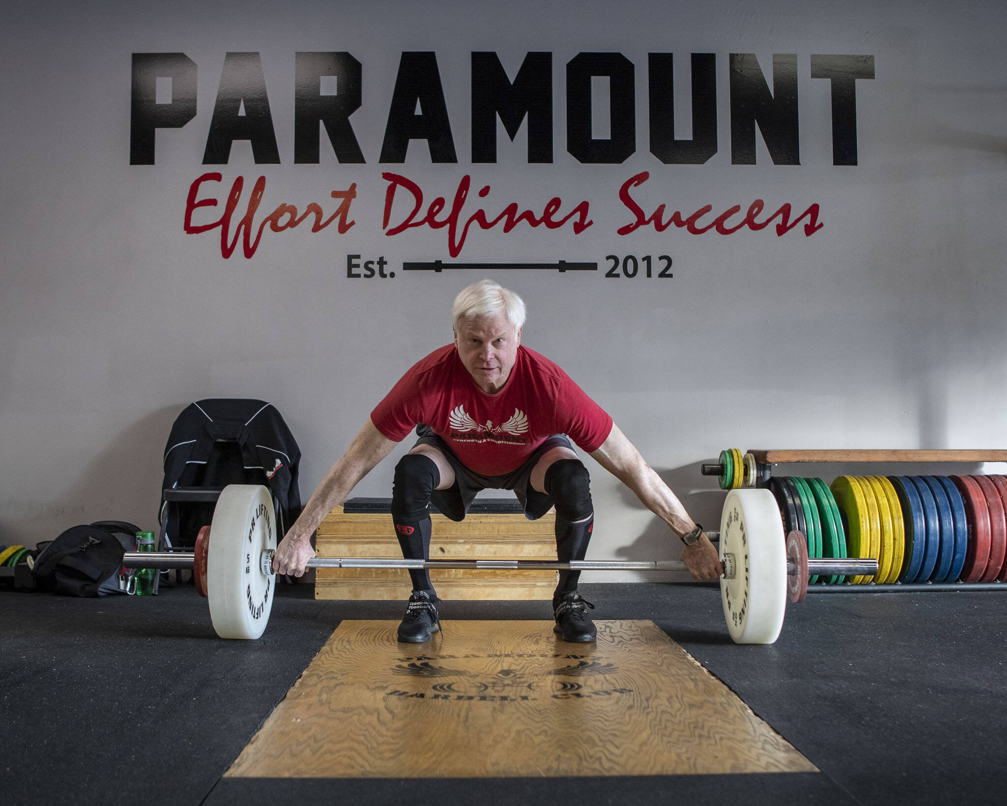 Phil Arnold, 74, practices his lifting techniques at Paramount Strength and Conditioning in Mountlake Terrace, Washington on Thursday, Feb. 2, 2023. The Edmonds resident is 74 and recently retired as an attorney. He took up weightlifting after retirement and recently won a national championship. (Annie Barker / The Herald)