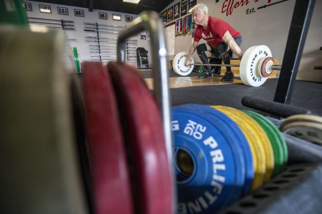 Phil Arnold, 74, practices his lifting techniques at Paramount Strength and Conditioning in Mountlake Terrace, Washington on Thursday, Feb. 2, 2023. The Edmonds resident is 74 and recently retired as an attorney. He took up weightlifting after retirement and recently won a national championship. (Annie Barker / The Herald)
