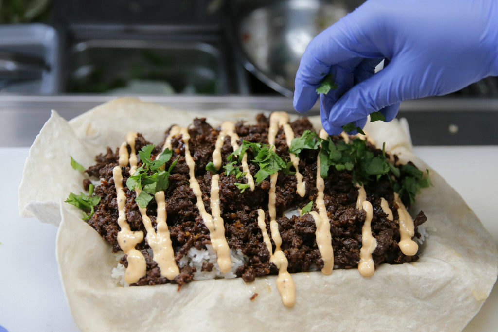 A kalbi steak burrito in the process of being created at Ryan’s REZ-ipes Friday afternoon at Skookum Brewery in Arlington on October 14, 2022. (Kevin Clark / The Herald)
