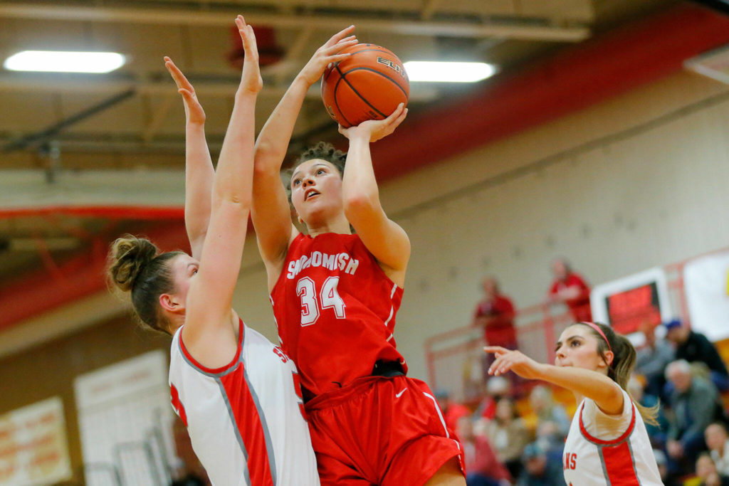 Snohomish’s Tyler Gildersleeve-Stiles sinks a contested jumper against Stanwood on Tuesday, Feb. 14, 2023, at Marysville Pilchuck High School in Marysville, Washington. (Ryan Berry / The Herald)
