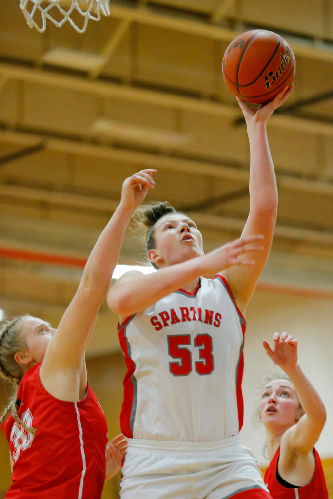 Stanwood’s Vivienne Berrett sinks a close range shot in a win over Snohomish on Tuesday, Feb. 14, 2023, at Marysville Pilchuck High School in Marysville, Washington. (Ryan Berry / The Herald)
