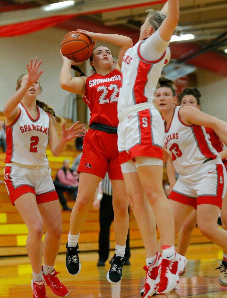 Snohomish’s Jada Andresen tries to get off a shot in a crowd of defenders against Stanwood on Tuesday, Feb. 14, 2023, at Marysville Pilchuck High School in Marysville, Washington. (Ryan Berry / The Herald)
