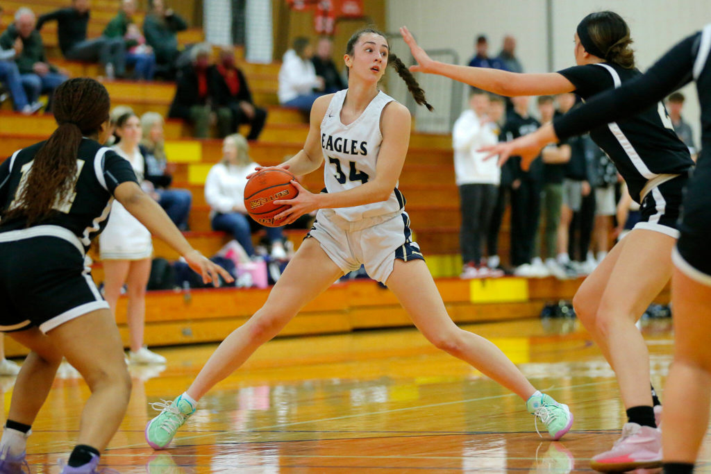 Arlington’s Jenna Villa steps away from a defender while looking to pass the ball against Lynnwood on Tuesday, Feb. 14, 2023, at Marysville Pilchuck High School in Marysville, Washington. (Ryan Berry / The Herald)
