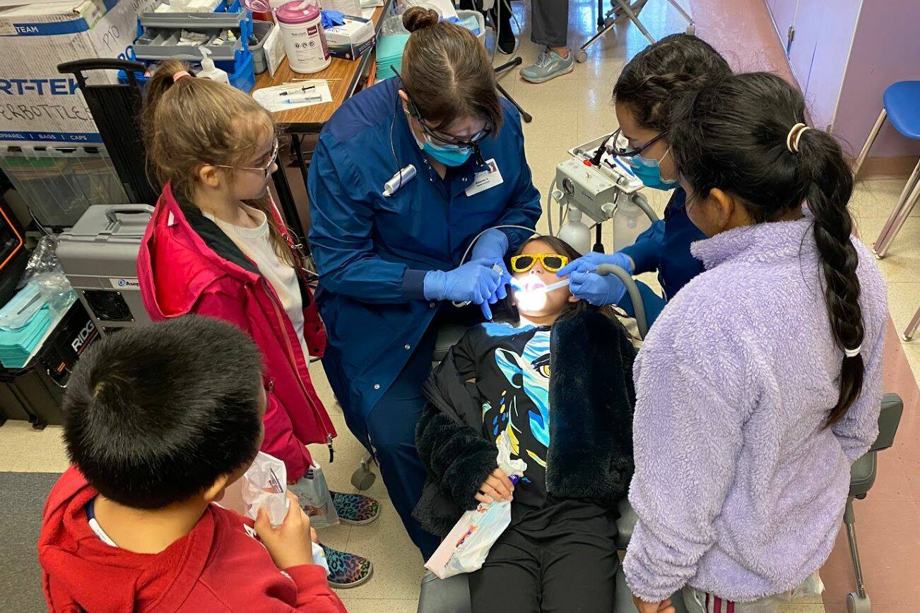 Children at Discovery Elementary School in Everett watch as Amanda Good seals molars Feb. 7. (Mukilteo School District)
