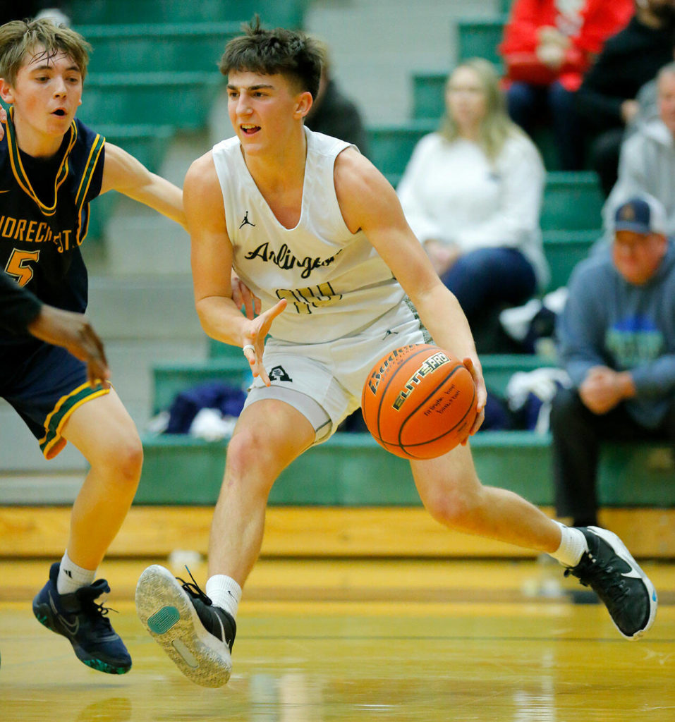 Arlington’s Jake Willis collects the ball before passing it off against Shorecrest on Wednesday, Feb. 15, 2023, at Jackson High School in Mill Creek, Washington. (Ryan Berry / The Herald)
