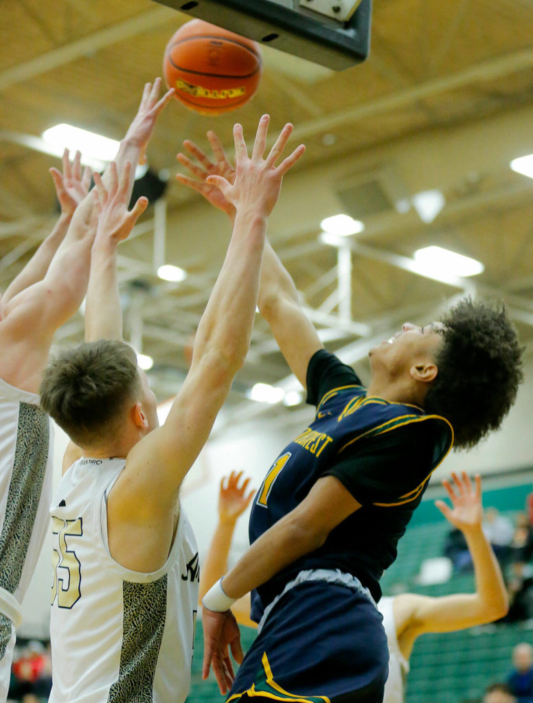 Shorecrest’s Keaine Silimon tries to connect on a layup in traffic against Arlington on Wednesday, Feb. 15, 2023, at Jackson High School in Mill Creek, Washington. (Ryan Berry / The Herald)
