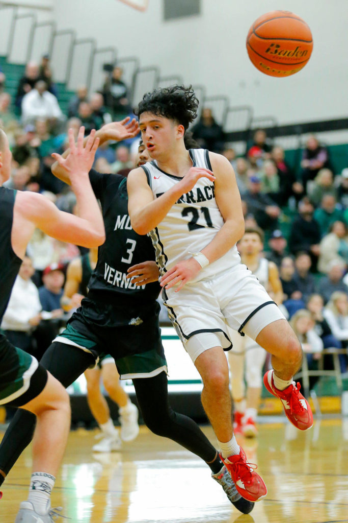 Mountlake Terrace’s Logan Tews distributes the ball with a no-look pass against Mount Vernon on Wednesday, Feb. 15, 2023, at Jackson High School in Mill Creek, Washington. (Ryan Berry / The Herald)
