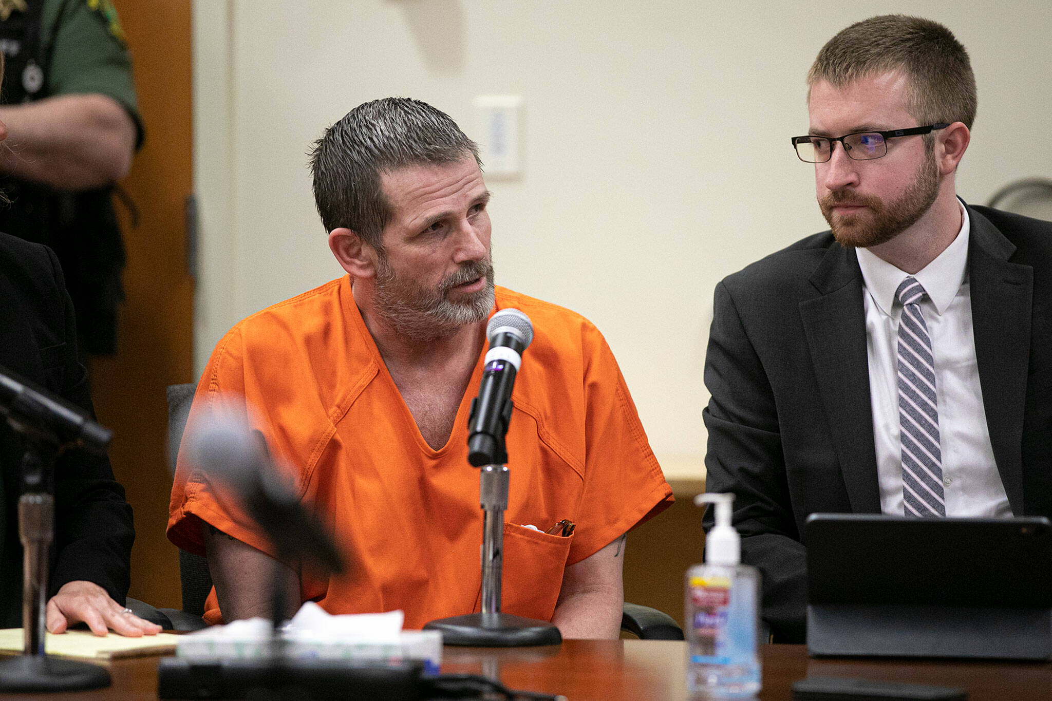 Richard Rotter sits between his attorneys while entering a not guilty plea on all three charges against him on April 25, 2022, at Snohomish County Court in Everett. (Ryan Berry / The Herald)