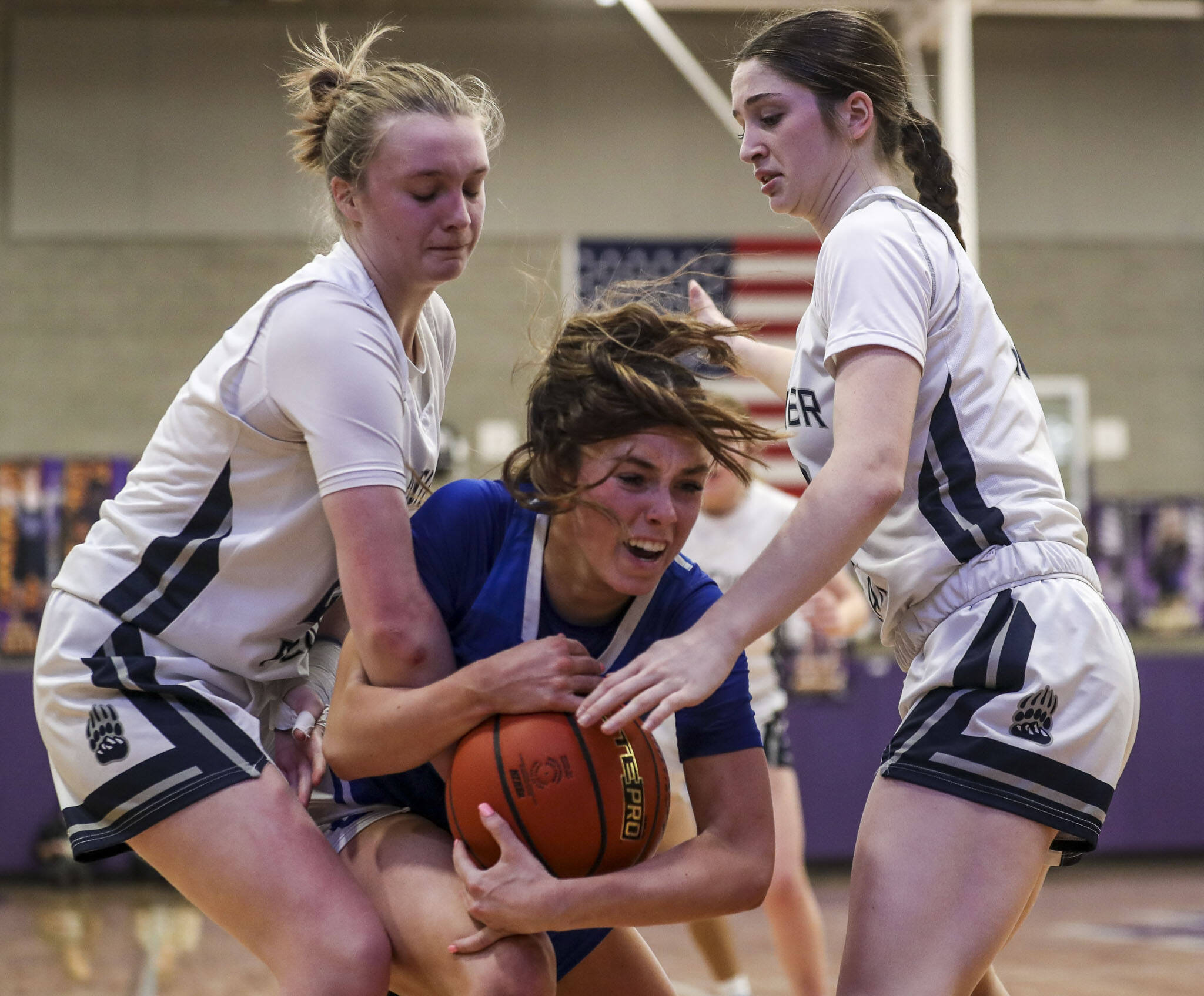 Bothell’s Ashlyn Peterson (13) fights to keep the ball through Glacier Peak defenders during a bi-district tournament game on Thursday afternoon at Lake Washington High School in Kirkland. (Annie Barker / The Herald)