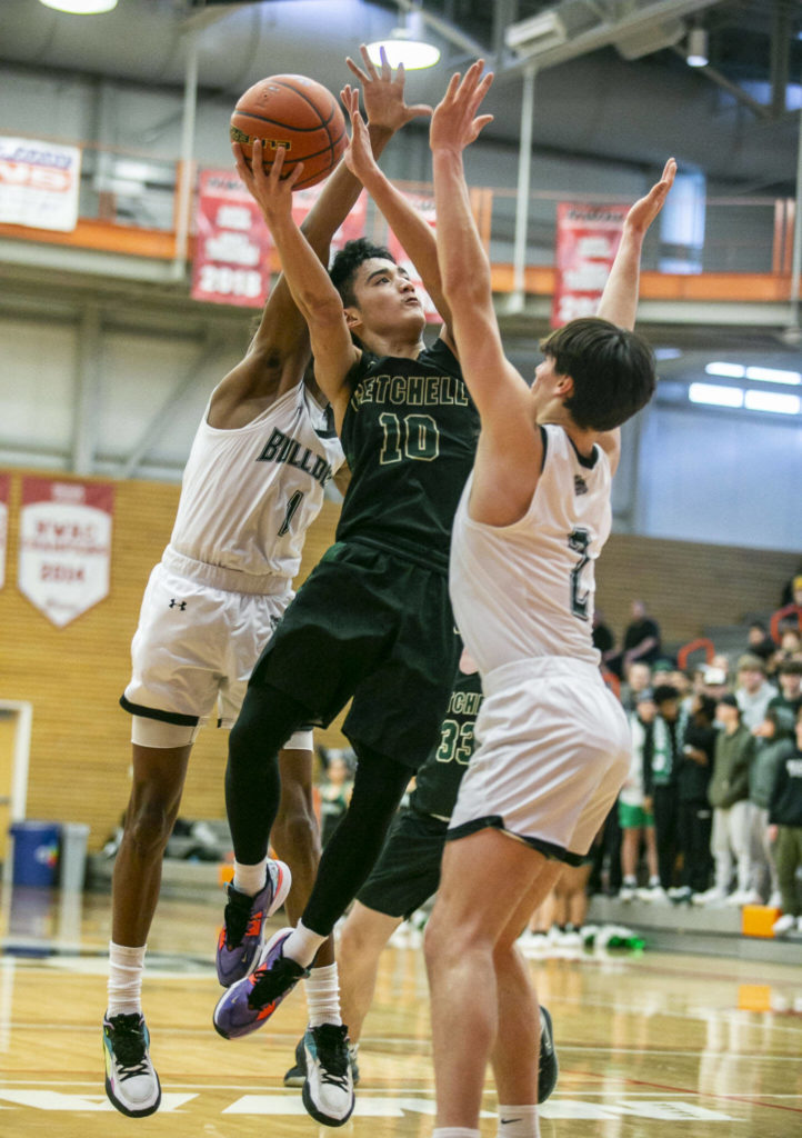 Marysville-Getchell’s Arion Palacol attempts a layup while being double teamed during the game against Mount Vernon on Friday, Feb. 17, 2023 in Everett, Washington. (Olivia Vanni / The Herald)
