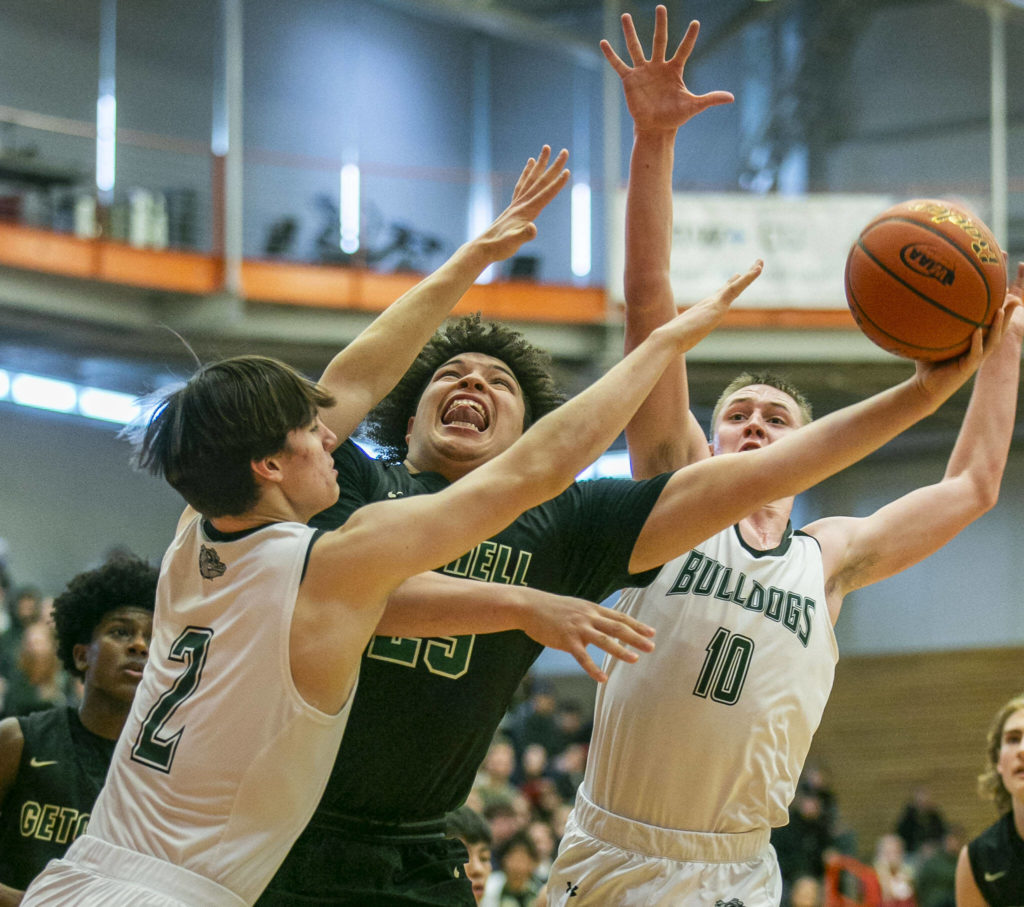 Marysville-Getchell’s Jayden Sellers attempts a layup being been double teamed during the game against Mount Vernon on Friday, Feb. 17, 2023 in Everett, Washington. (Olivia Vanni / The Herald)
