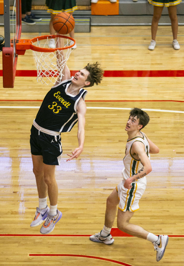 Everett’s Hayden Conaxis dunks the ball during the game against Shorecrest on Friday, Feb. 17, 2023 in Everett, Washington. (Olivia Vanni / The Herald)
