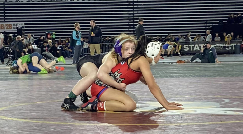 Kamiak’s Rebecca Serati (left) wrestles Pasco’s Elisa Sanchez in a 4A/3A girls 105-pound match during the first day of Mat Classic XXXIV on Feb. 17, 2023, at the Tacoma Dome. (Zac Hereth / The Herald)

