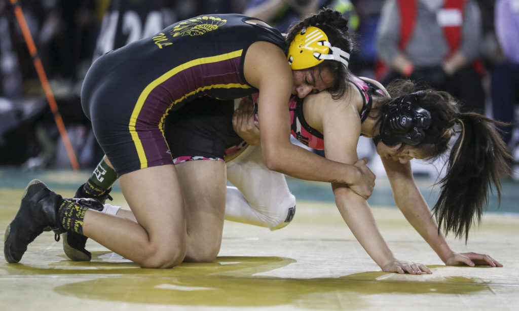 Marysville Getchell’s Kira Songer and Moses Lake’s Ashley Dayana Naranjo wrestle in the 3A/4A Girls 115-pound championship match during the Mat Classic XXXIV at the Tacoma Dome in Tacoma, Washington on Saturday, Feb. 18, 2023. (Annie Barker / The Herald)
