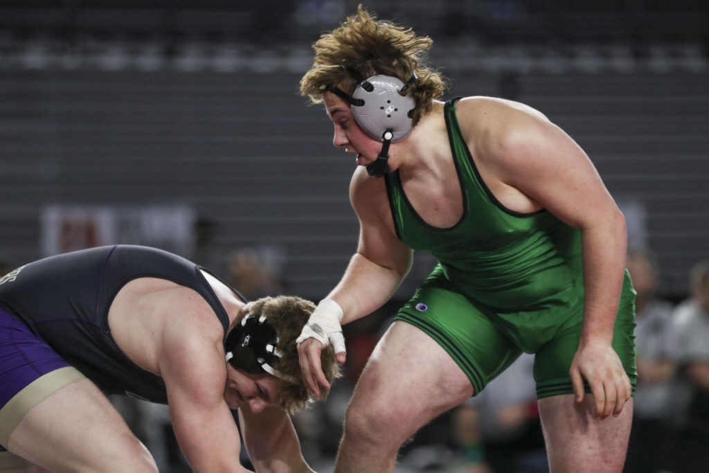 Lake Stevens’ Koen Mattern and Kentwood’s Chase Baker wrestle during the 4A Boys 220-pound championship match during the Mat Classic XXXIV at the Tacoma Dome in Tacoma, Washington on Saturday, Feb. 18, 2023. (Annie Barker / The Herald)
