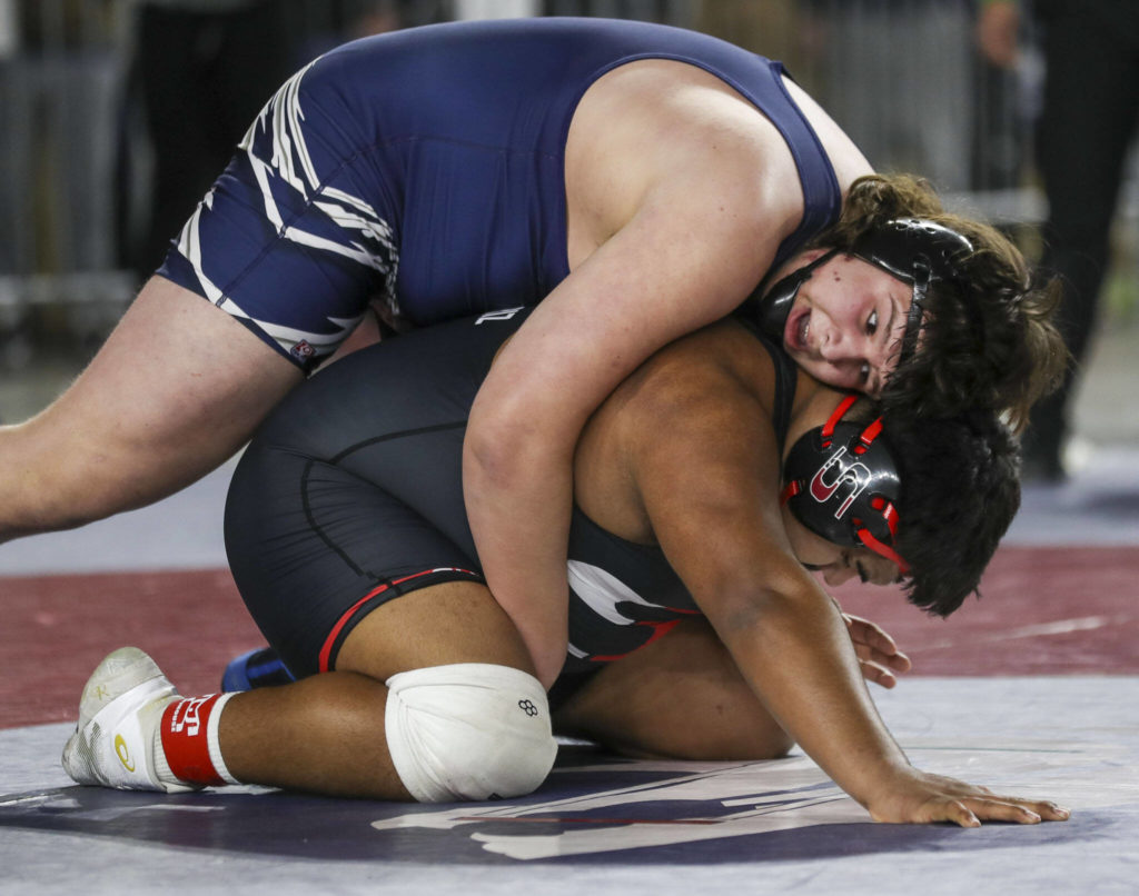 Glacier Peak’s Connor Aney and Sunnyside’s Mateo Armendariz wrestle during the 4A Boys 285-pound championship match during the Mat Classic XXXIV at the Tacoma Dome in Tacoma, Washington on Saturday, Feb. 18, 2023. (Annie Barker / The Herald)

