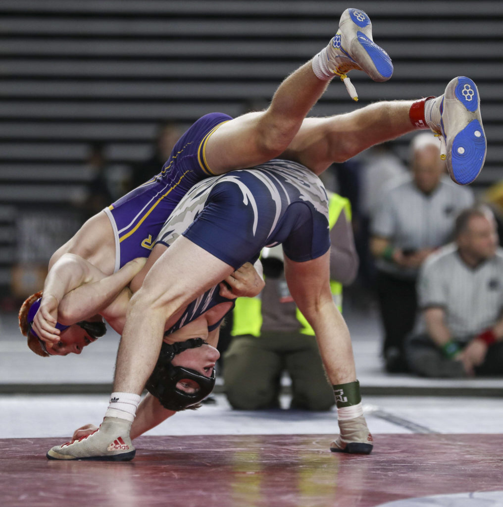 Sumner’s Cody Miller and Glacier Peak’s Gil Mossburg wrestle during the 4A Boys 145-pound championship match during the Mat Classic XXXIV at the Tacoma Dome in Tacoma, Washington on Saturday, Feb. 18, 2023. (Annie Barker / The Herald)
