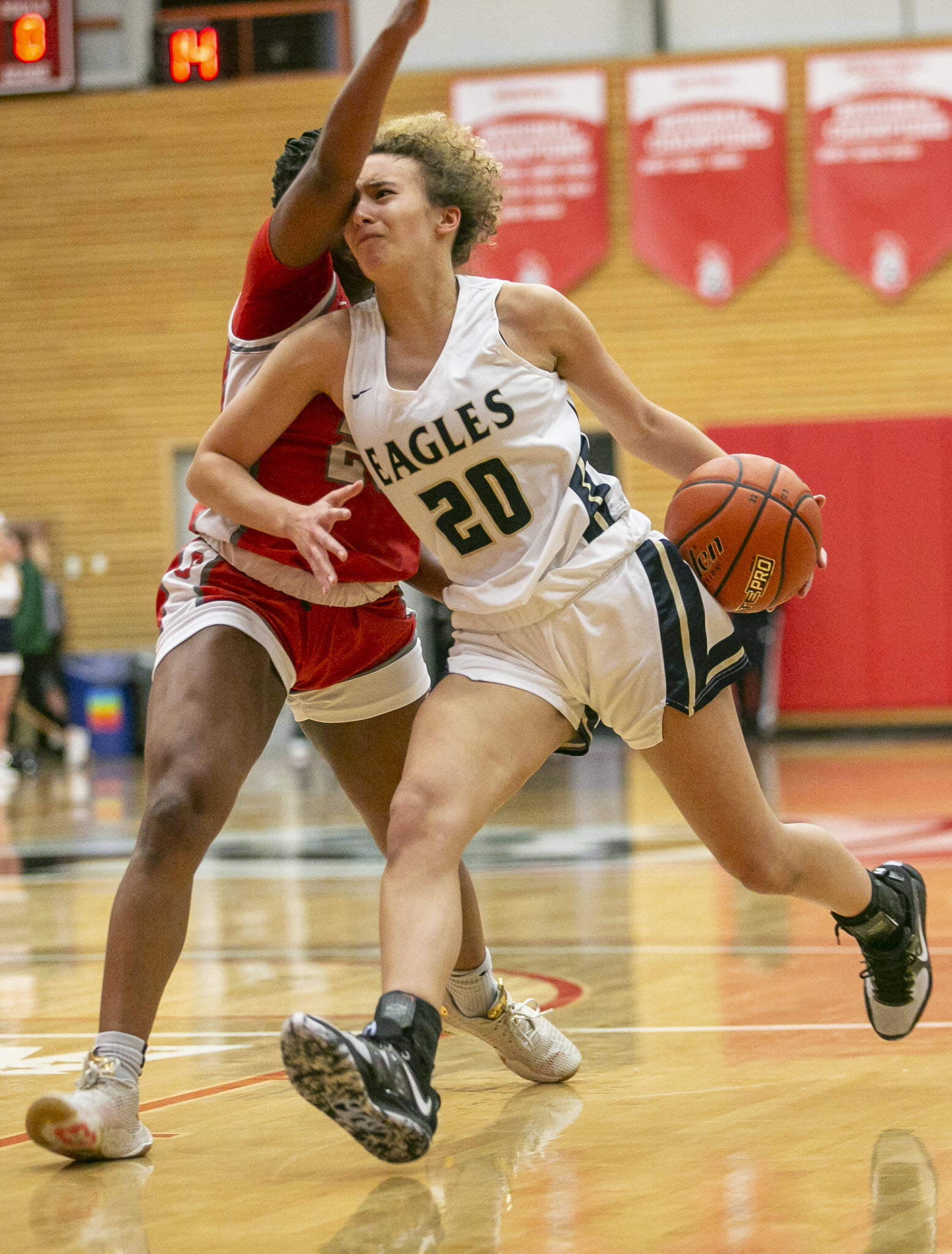 Arlington’s Samara Morrow is fouled as she drives to the hoop during the game against Stanwood on Saturday, Feb. 18, 2023 in Everett, Washington. (Olivia Vanni / The Herald)