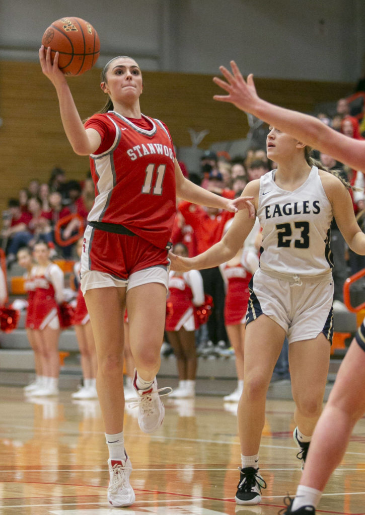 Stanwood’s Tatum Brager attempts to pass the pall to a teammate during the game against Arlington on Saturday, Feb. 18, 2023 in Everett, Washington. (Olivia Vanni / The Herald)
