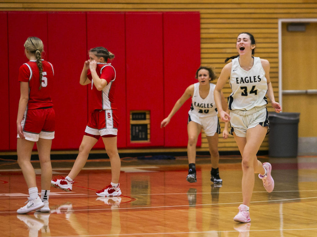 Arlington’s Jenna Villa yells in celebration after beating Stanwood to become 3A District 1 champions on Saturday, Feb. 18, 2023 in Everett, Washington. (Olivia Vanni / The Herald)
