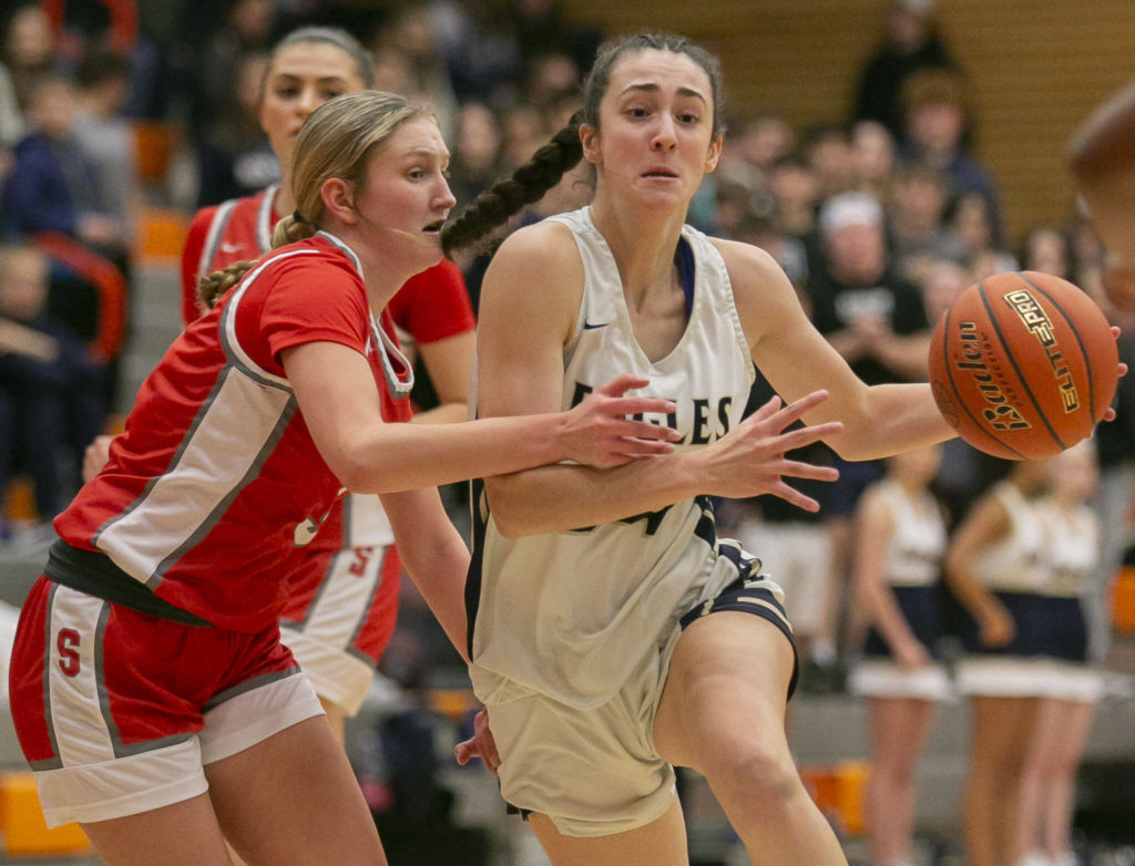 Arlington’s Jenna Villa tries to maneuver around a defender during the game against Stanwood on Saturday, Feb. 18, 2023 in Everett, Washington. (Olivia Vanni / The Herald)
