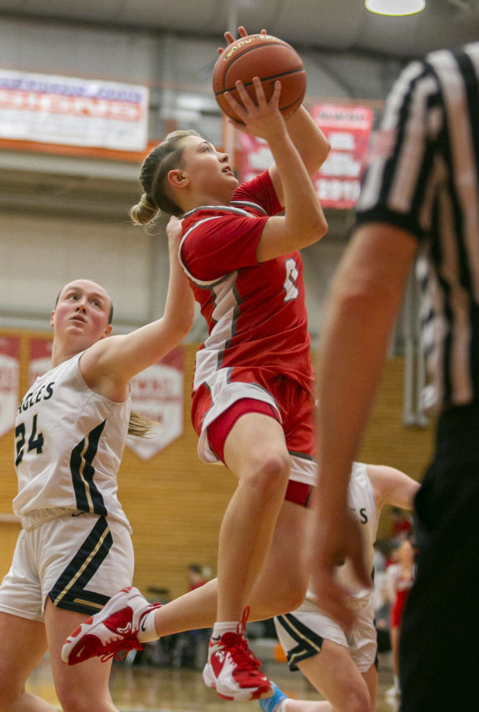 Stanwood’s Grace Walker attempts a layup during the game against Arlington on Saturday, Feb. 18, 2023 in Everett, Washington. (Olivia Vanni / The Herald)
