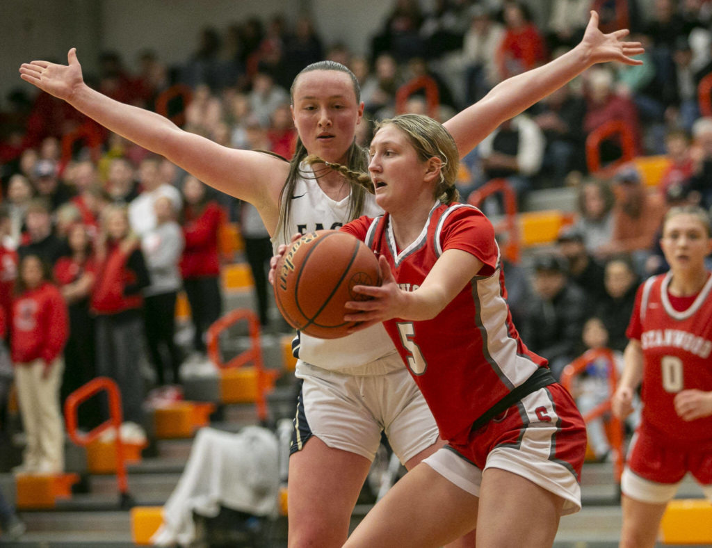 Stanwood’s Ava Depew attempts to keep the ball away from Arlington’s Katie Snow during the game on Saturday, Feb. 18, 2023 in Everett, Washington. (Olivia Vanni / The Herald)
