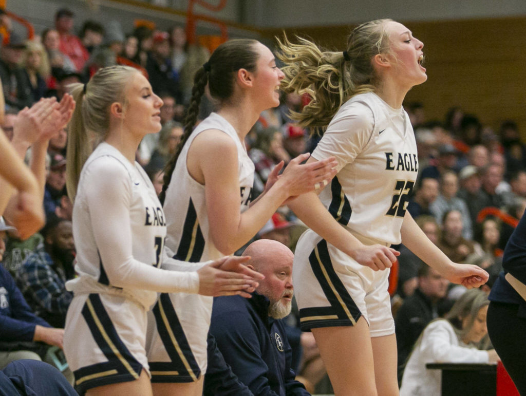 Arlington’s Kierra Reese yells in reaction to a score by a teammate during the game against Stanwood on Saturday, Feb. 18, 2023 in Everett, Washington. (Olivia Vanni / The Herald)
