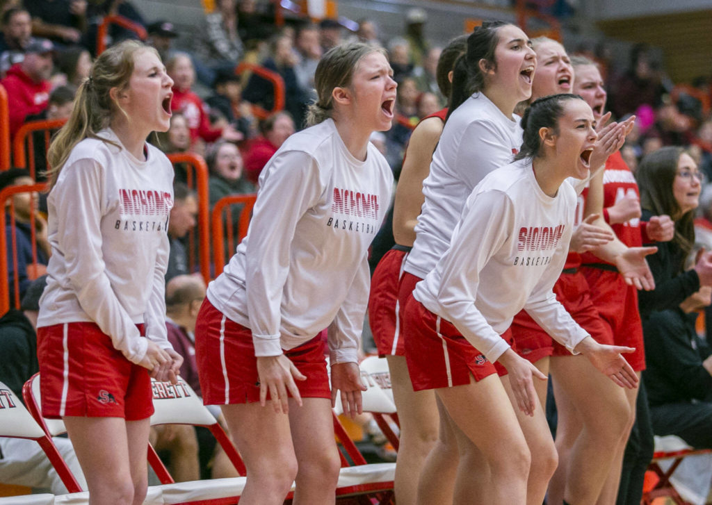 The Snohomish bench reacts to a score during the game against Everett on Saturday, Feb. 18, 2023 in Everett, Washington. (Olivia Vanni / The Herald)
