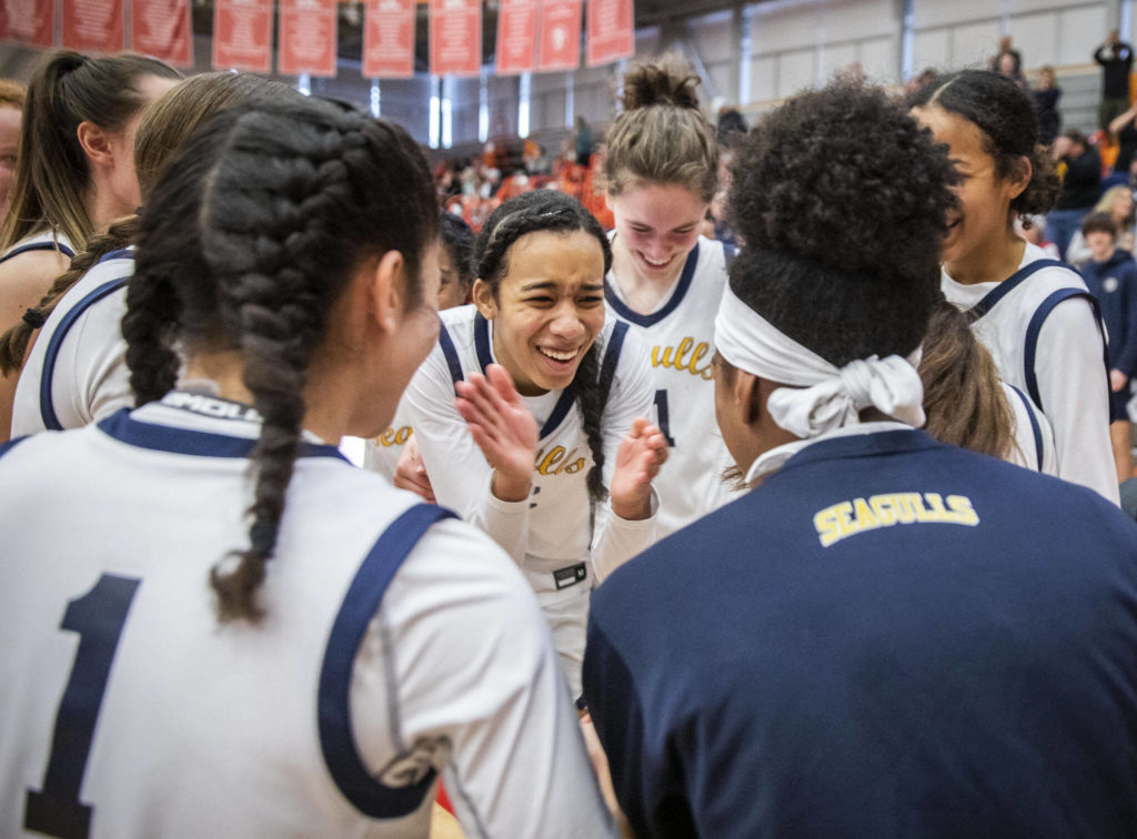 Everett’s Alana Washington reacts in a huddle to beating Snohomish to advance to state after the game on Saturday, Feb. 18, 2023 in Everett, Washington. (Olivia Vanni / The Herald)
