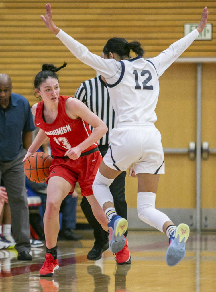 Snohomish’s Sienna Capelli looks for an open teammate to pass too while being guarded during the game against Everett on Saturday, Feb. 18, 2023 in Everett, Washington. (Olivia Vanni / The Herald)
