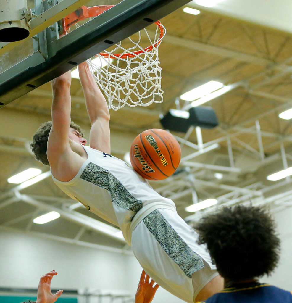 Arlington’s David Zachman dunks the ball to extend his team’s lead against Shorecrest on Feb. 15 at Jackson High School in Mill Creek. The 12th-seeded Eagles face 20th-seeded Walla Walla on Saturday. (Ryan Berry / The Herald)
