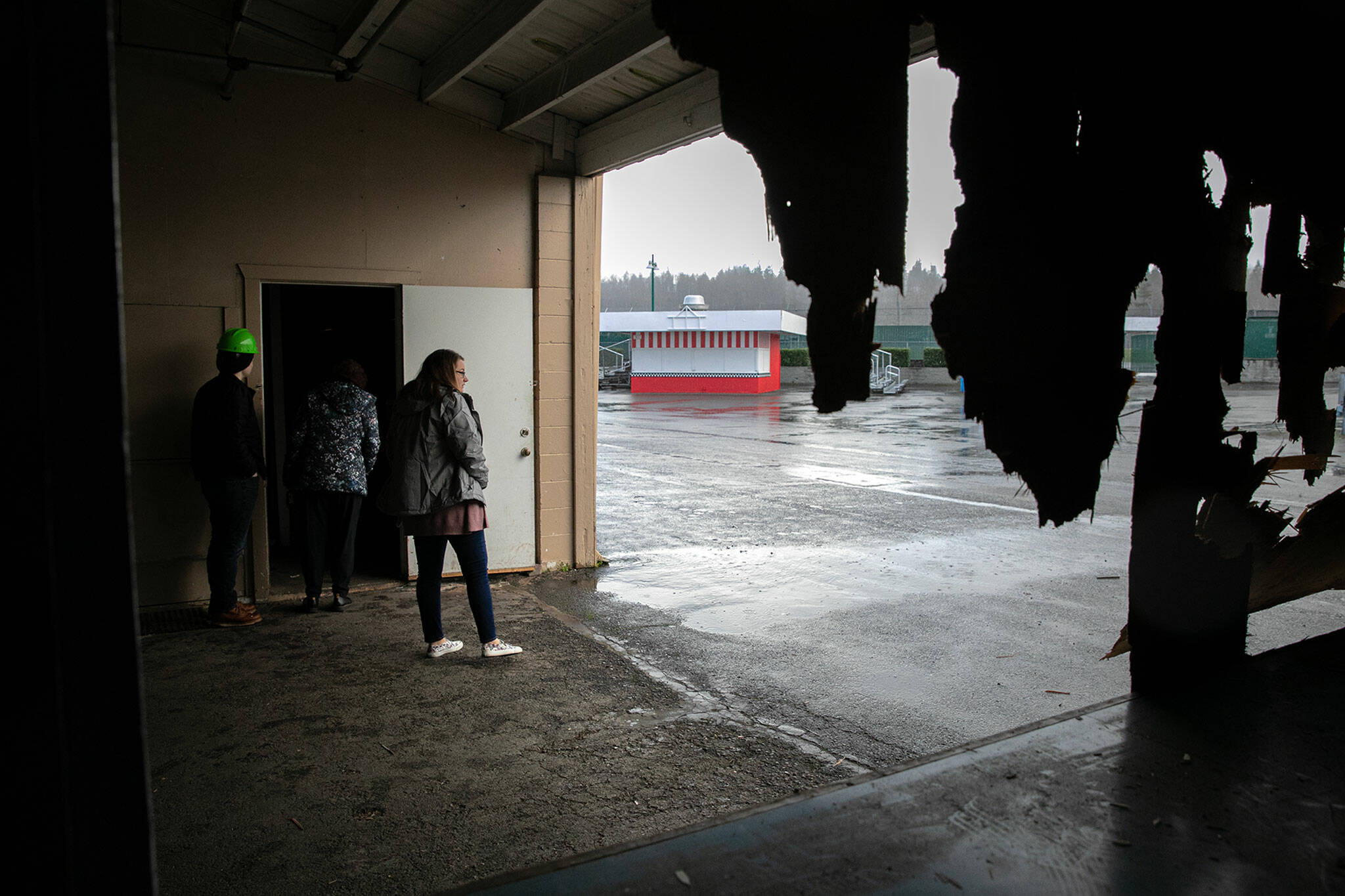 Visitors take one last look around Commercial Building No. 400 during an event celebrating the impending demolition of the derelict space on Tuesday, at the Evergreen State Fairgrounds in Monroe. (Ryan Berry / The Herald)
