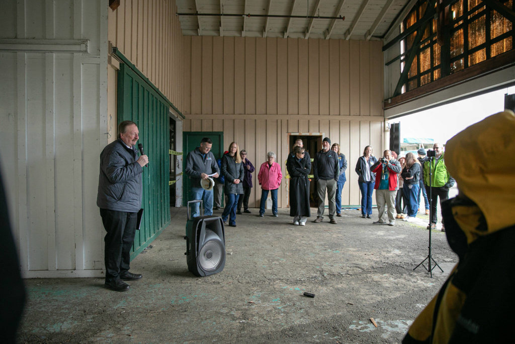 Members of the public gather for a brief ceremony during an event celebrating the impending demolition of Commercial Building No. 400 Tuesday, at the Evergreen State Fairgrounds in Monroe. (Ryan Berry / The Herald)
