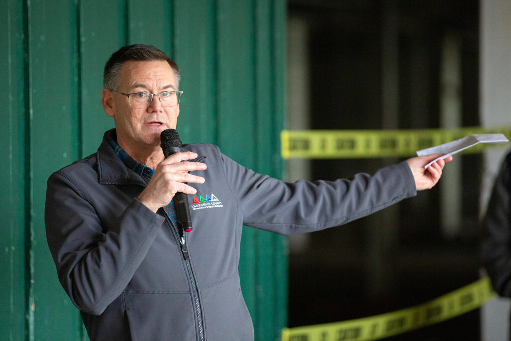 Tom Teigen, Director of Snohomish County Conservation and Natural Resources, speaks during an event celebrating the impending demolition of Commercial Building No. 400 Tuesday, at the Evergreen State Fairgrounds in Monroe. (Ryan Berry / The Herald)
