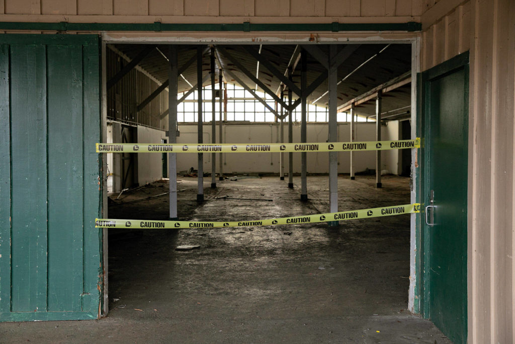 The inside of Commercial Building No. 400 is taped off during an event celebrating the impending demolition of the derelict space Tuesday, at the Evergreen State Fairgrounds in Monroe. (Ryan Berry / The Herald) 
