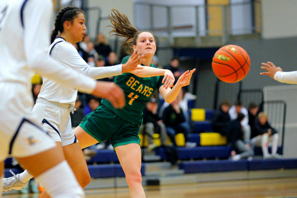 Bishop Blanchet’s Sadie Graves passes the ball against Everett during a first round playoff game on Tuesday, Feb. 21, 2023, at the Norm Lowery Gymnasium in Everett, Washington. (Ryan Berry / The Herald)
